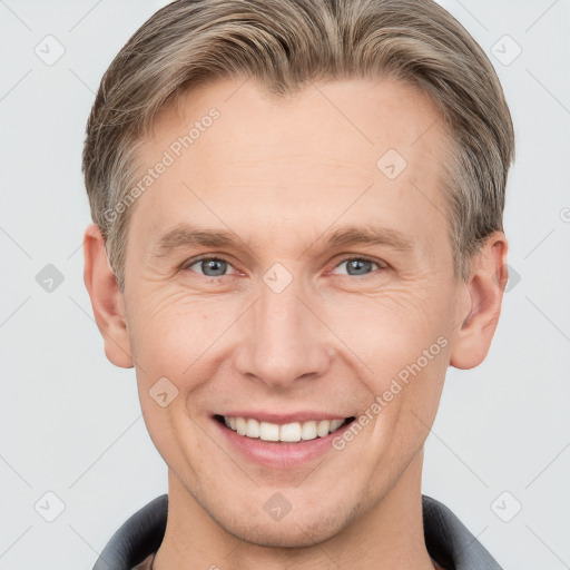 Joyful white adult male with short  brown hair and grey eyes