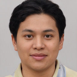 Joyful asian young-adult male with short  brown hair and brown eyes