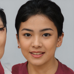 Joyful asian young-adult female with short  black hair and brown eyes