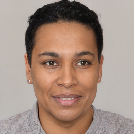 Joyful latino adult male with short  black hair and brown eyes
