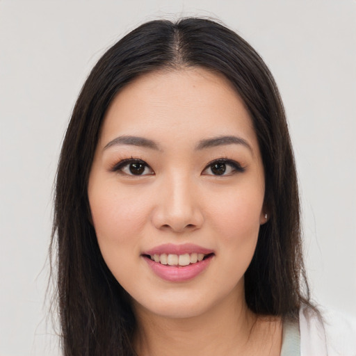 Joyful asian young-adult female with long  brown hair and brown eyes