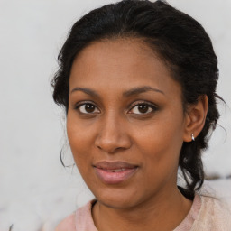 Joyful black young-adult female with medium  brown hair and brown eyes