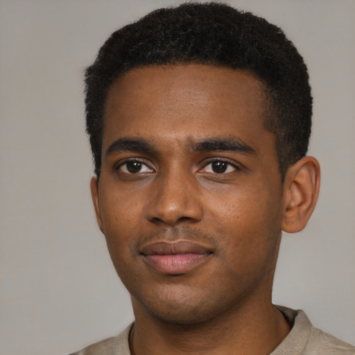 Joyful black young-adult male with short  brown hair and brown eyes