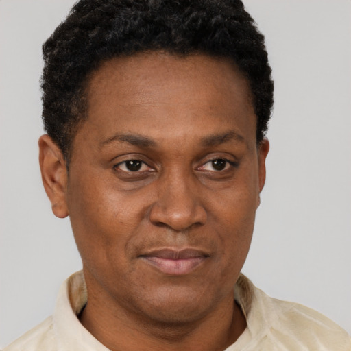 Joyful black adult male with short  brown hair and brown eyes