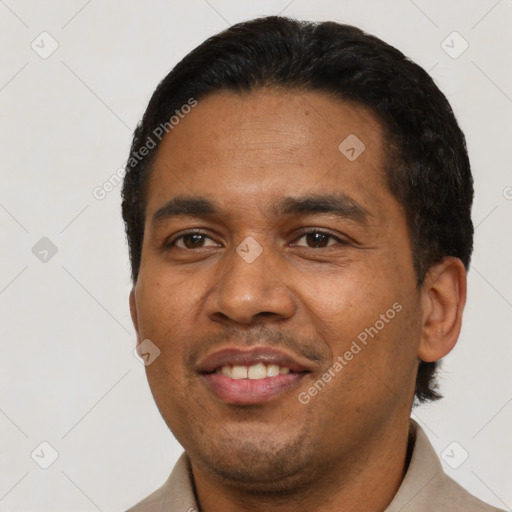Joyful latino adult male with short  black hair and brown eyes