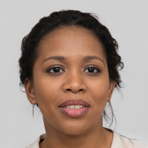 Joyful black young-adult female with medium  brown hair and brown eyes