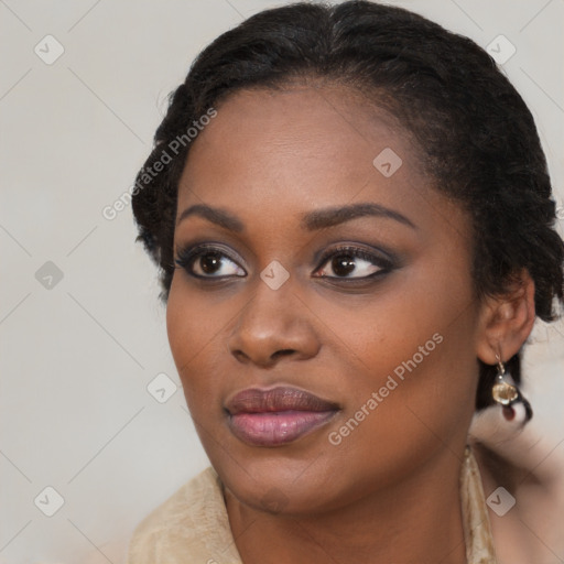 Joyful black young-adult female with long  brown hair and brown eyes