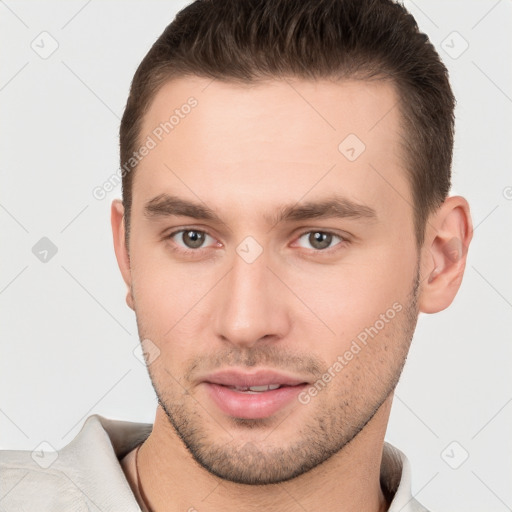 Joyful white young-adult male with short  brown hair and brown eyes