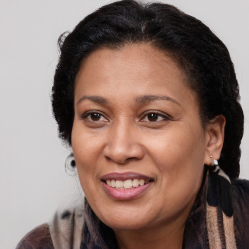 Joyful latino adult female with medium  brown hair and brown eyes