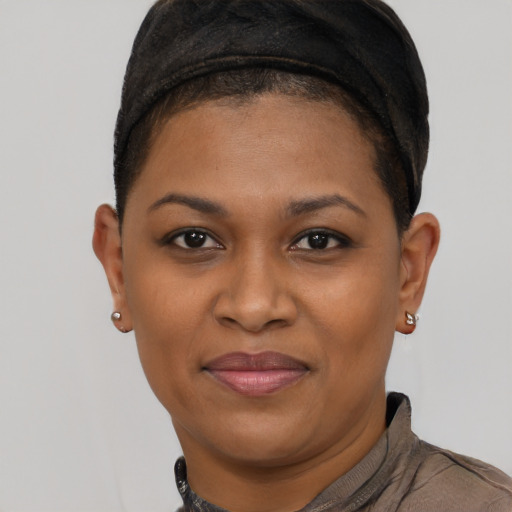 Joyful black young-adult female with short  brown hair and brown eyes
