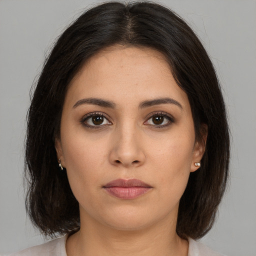 Joyful white young-adult female with medium  brown hair and brown eyes