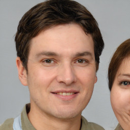 Joyful white adult male with short  brown hair and brown eyes