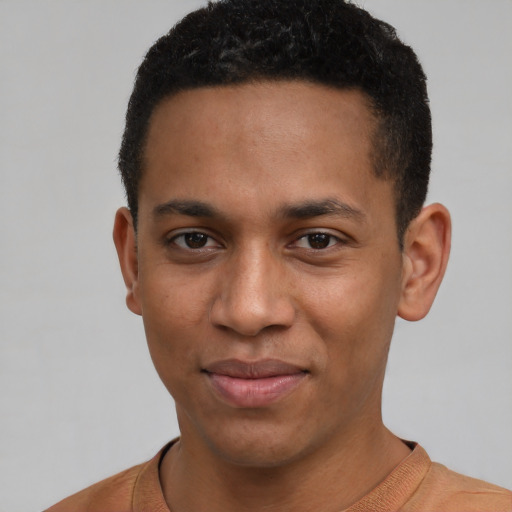 Joyful black young-adult male with short  black hair and brown eyes