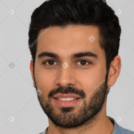 Joyful white young-adult male with short  black hair and brown eyes