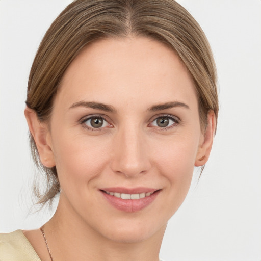 Joyful white young-adult female with medium  brown hair and grey eyes