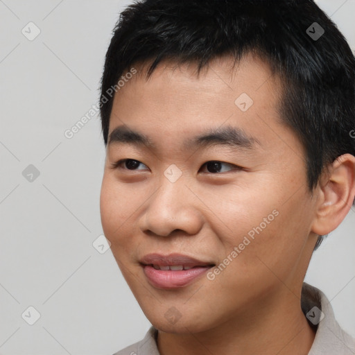 Joyful asian young-adult male with short  black hair and brown eyes