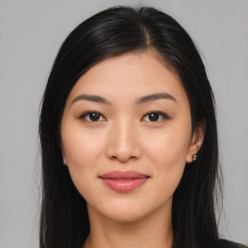 Joyful asian young-adult female with long  black hair and brown eyes