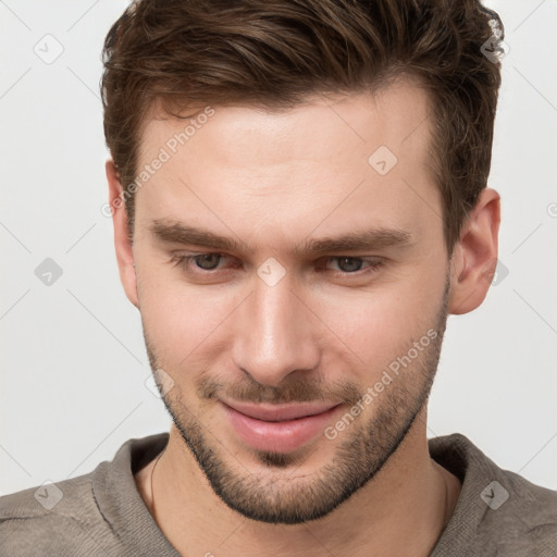 Joyful white young-adult male with short  brown hair and grey eyes