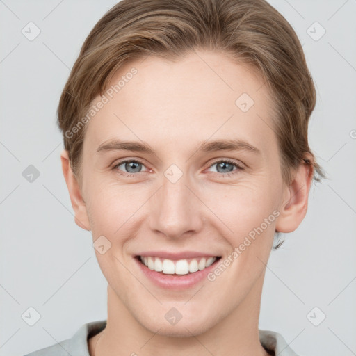 Joyful white young-adult female with short  brown hair and grey eyes