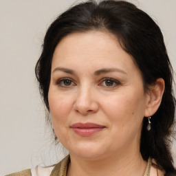 Joyful white adult female with medium  brown hair and brown eyes