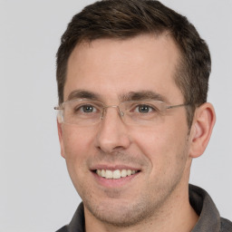 Joyful white adult male with short  brown hair and brown eyes