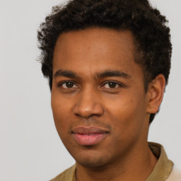 Joyful black young-adult male with short  brown hair and brown eyes