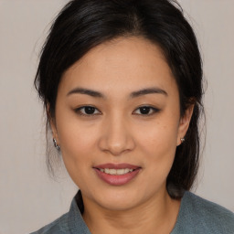 Joyful asian young-adult female with medium  brown hair and brown eyes