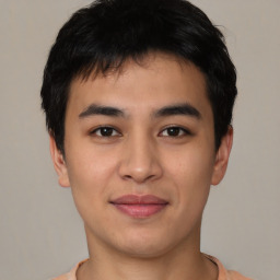 Joyful asian young-adult male with short  brown hair and brown eyes