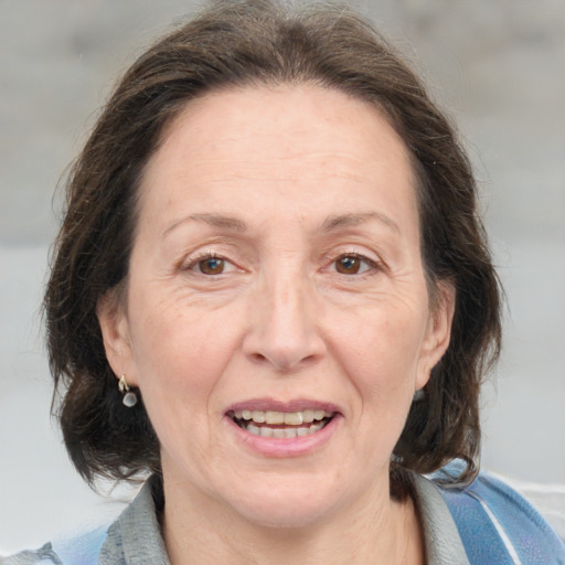 Joyful white adult female with medium  brown hair and grey eyes