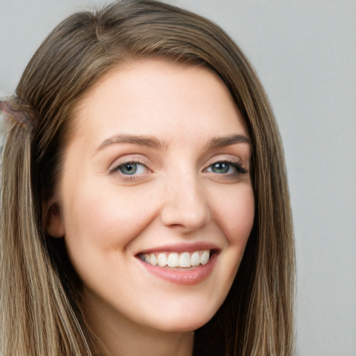 Joyful white young-adult female with long  brown hair and grey eyes