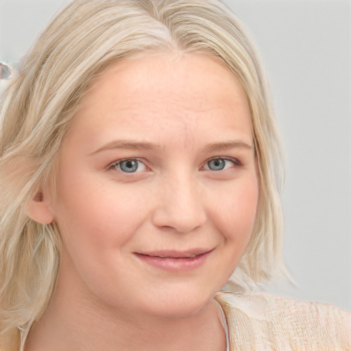 Joyful white young-adult female with medium  blond hair and blue eyes