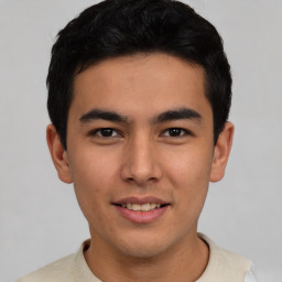 Joyful asian young-adult male with short  black hair and brown eyes