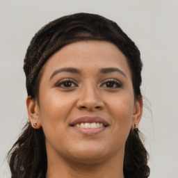 Joyful latino young-adult female with long  brown hair and brown eyes