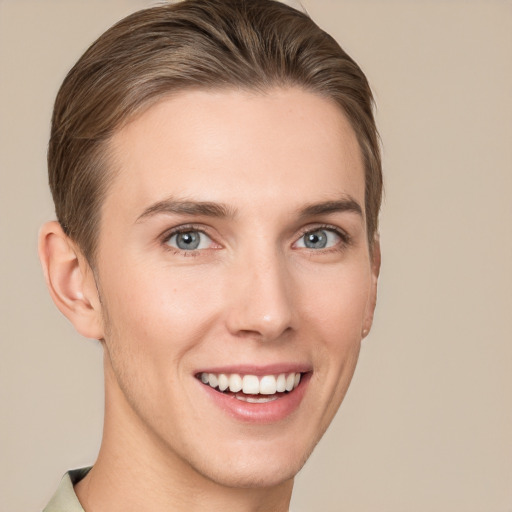 Joyful white young-adult female with short  brown hair and grey eyes