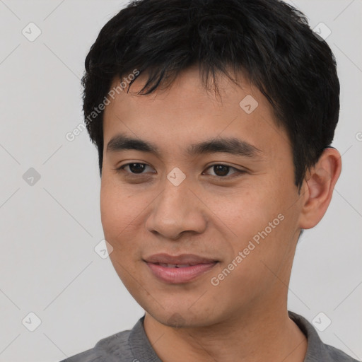 Joyful asian young-adult male with short  black hair and brown eyes