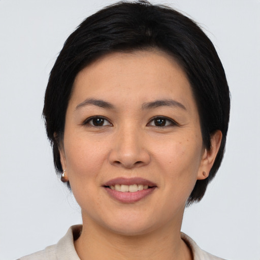Joyful asian young-adult female with medium  black hair and brown eyes