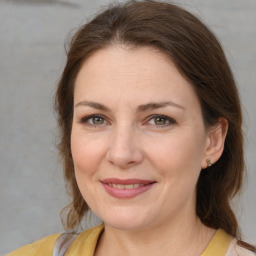 Joyful white adult female with medium  brown hair and brown eyes