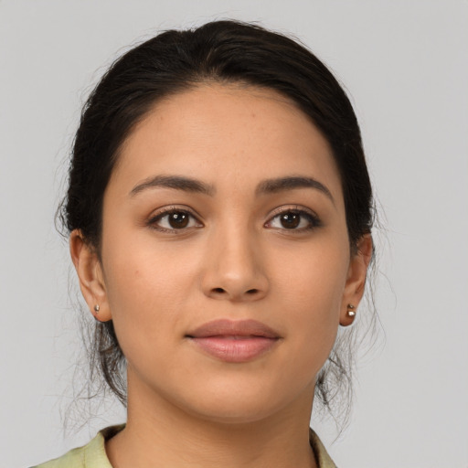 Joyful latino young-adult female with medium  brown hair and brown eyes