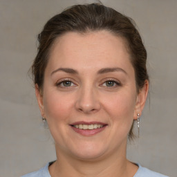 Joyful white adult female with medium  brown hair and grey eyes