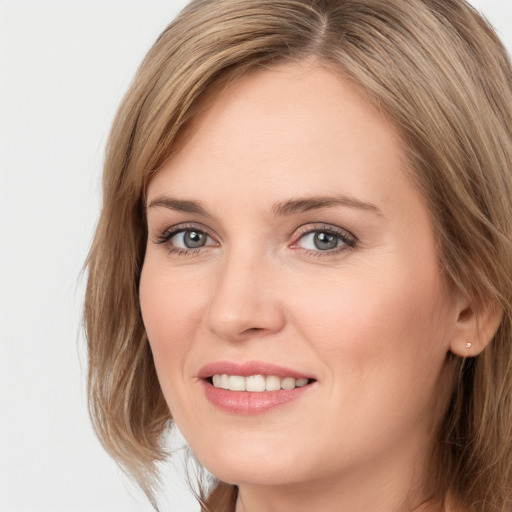 Joyful white young-adult female with long  brown hair and grey eyes