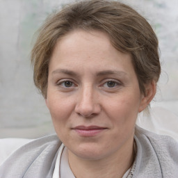 Joyful white adult female with short  brown hair and grey eyes