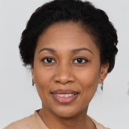 Joyful latino adult female with short  brown hair and brown eyes