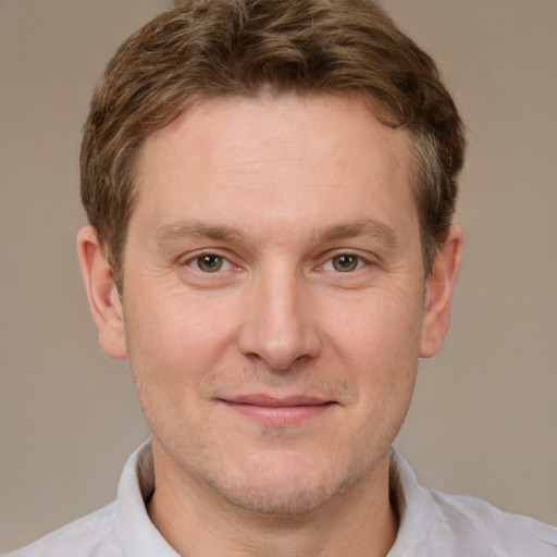 Joyful white adult male with short  brown hair and brown eyes