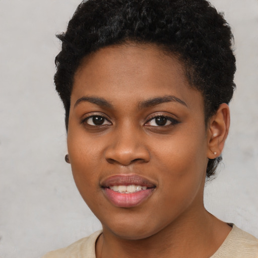 Joyful black young-adult female with short  brown hair and brown eyes