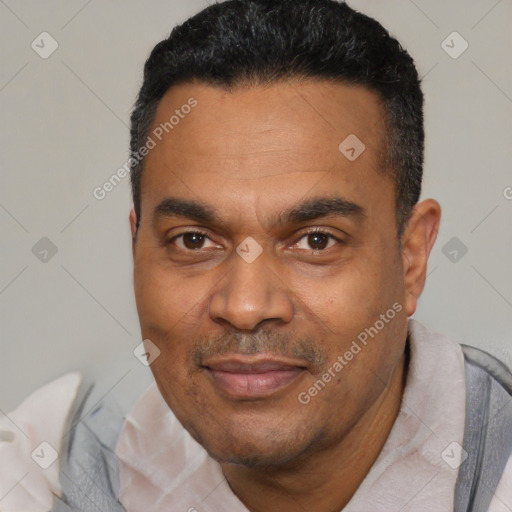 Joyful latino adult male with short  black hair and brown eyes