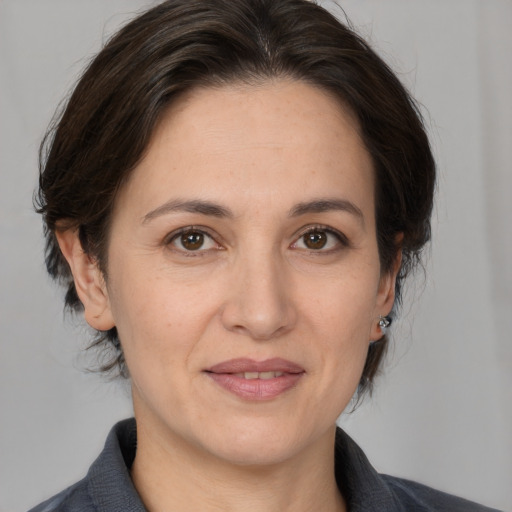 Joyful white adult female with medium  brown hair and brown eyes