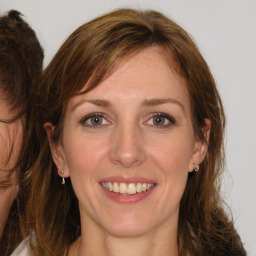 Joyful white adult female with medium  brown hair and brown eyes