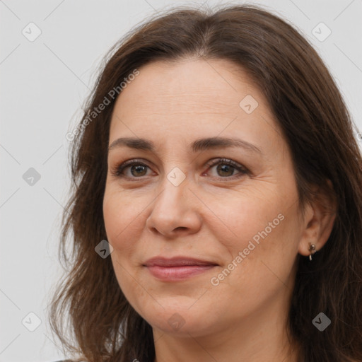 Joyful white adult female with long  brown hair and brown eyes