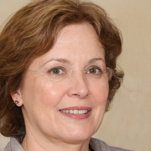 Joyful white middle-aged female with medium  brown hair and blue eyes