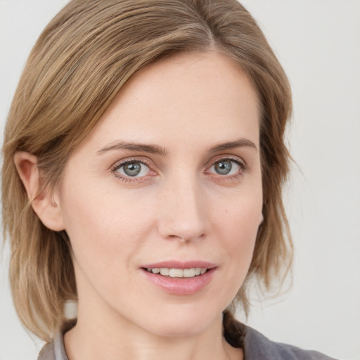 Joyful white young-adult female with medium  brown hair and blue eyes